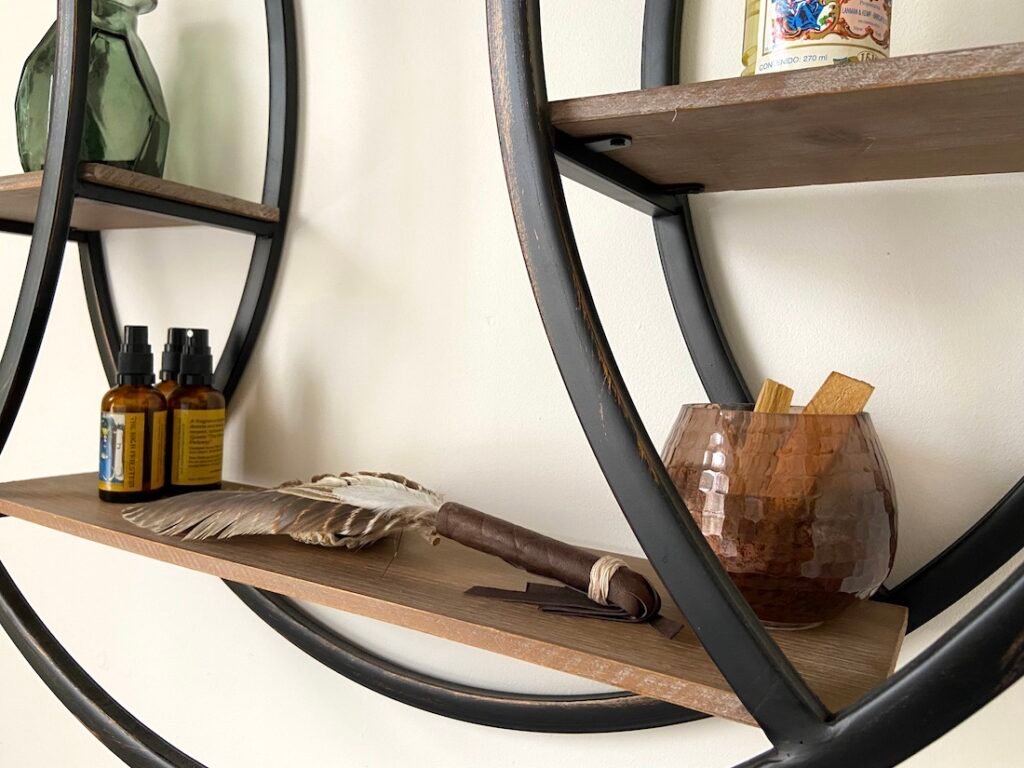 Shelf detail with shamanic feather and palo Santo in treatment room 2 at the Holding Space 