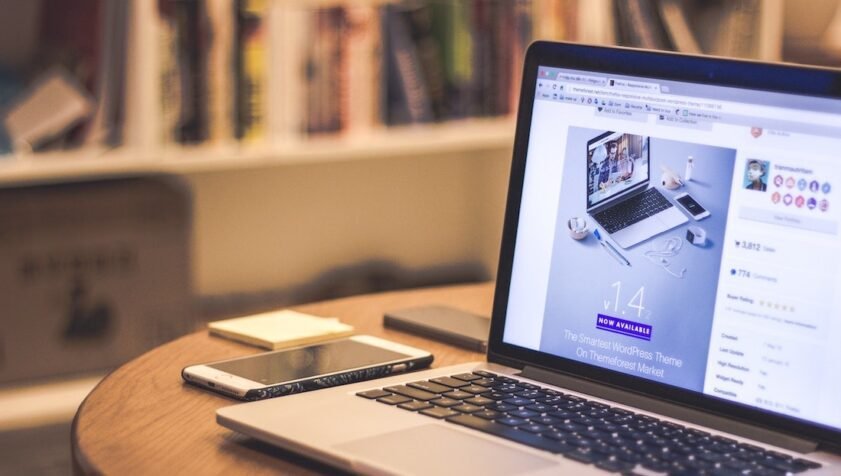 Image of a laptop on a coffee table, online business coaching for therapists and coaches at The Holding Space therapy rooms London